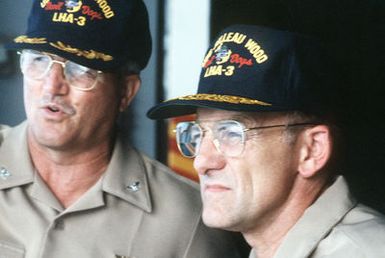 CAPT Douglas Bradt, left, commanding officer of the amphibious assault ship USS BELLEAU WOOD (LHA-3), left, and RADM William Retz, right, commander, Naval Base, Pearl Harbor, watch from the bridge as landing craft and helicopters deliver supplies from the BELLEAU WOOD to the island of Kanai in the aftermath of Hurrican Iniki. The delivery is being made as part of Joint Task Force Garden Isle, a joint military disaster relief effort