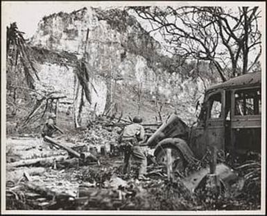 Wary leathernecks cautiously advance through a former Japanese bivouac area to the northeast of the airport on the island of Peleliu