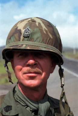 Command SGM John L. Hollis of the 1ST Bn., 35th Inf. Div., looks on as the final advance towards the opposing forces gets underway during Operation Thunderbolt