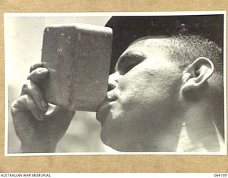MOUNT PROTHERO AREA, NEW GUINEA. 1944-01-20. VX55260 PRIVATE J. KENNEDY, "A" COMPANY, 2/12TH INFANTRY BATTALION ENJOYING A LONG CUP OF TEA BEFORE GOING INTO ACTION PRIOR TO THE ATTACK ON THE ENEMY ..