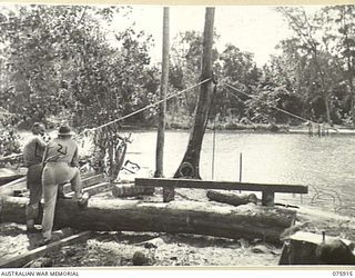 HANSA BAY, NEW GUINEA. 1944-09-06. ENGINEERS OF THE 25TH INFANTRY BATTALION DOING THE PREPARATORY WORK ON THE CONSTRUCTION OF A NEW BRIDGE ACROSS THE BOT BOT RIVER. SUPERVISING THE OPERATIONS ARE: ..