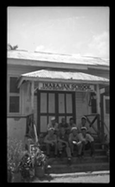 [Servicemen sitting outside Inarajan School]