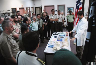 Forensic Anthropologist Elias Kontanis (white lab coat), Joint Prisoner of War/Missing in Action (POW/MIA) Accounting Command (JPAC), briefs international visitors from the U.S. Army War College on Feb. 15, 2007, at the JPAC Central Identification Laboratory (CIL), Hickam Air Force Base, Hawaii. Mr. Kontanis is one of the scientists tasked with identifying the remains of Americans recovered from sites around the world. The JPAC CIL is the largest forensic anthropology laboratory in the world. (U.S. Army photo by CPL. Arthur Lagrimus) (Released)