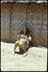 Susan Pflanz-Cook in front of woven house wall