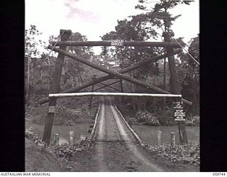 DONADABU, NEW GUINEA. 1943-11-03. A LIGHT SUSPENSION BRIDGE OR 'DAMOUR BRIDGE' BUILT OVER A CREEK NEAR THE LALOKI RIVER AT 24TH AUSTRALIAN FIELD COMPANY, ROYALY AUSTRALIAN ENGINEERS. OWING TO THE ..