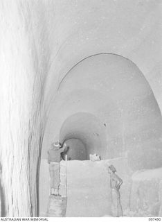 TUNNEL HILL ROAD, RABAUL, NEW BRITAIN. 1945-10-03. THE INTERIOR OF A LARGE TUNNEL WITH SMALLER BRANCHES LEADING OFF. THE JAPANESE MADE EXTENSIVE USE OF TUNNEL SYSTEMS IN THE RABAUL AREA AFTER ..