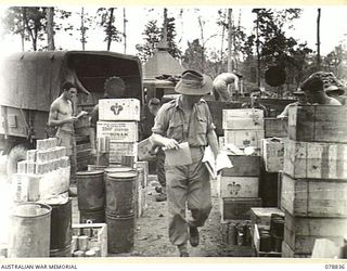 TOROKINA, BOUGAINVILLE ISLAND. 1945-01-30. SUPPLIES FOR AUSTRALIAN UNITS IN THE AREA BEING LOADED ON TO TRUCKS AT THE 4TH SUPPLY DEPOT PLATOON