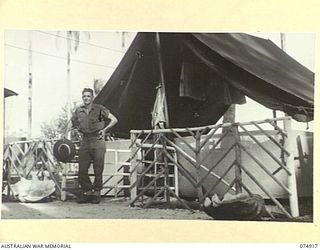 SOUTH ALEXISHAFEN, NEW GUINEA. 1944-07-24. QX27175 WARRANT OFFICER II, E.R. FRASER, REGIMENTAL SERGEANT MAJOR, OUTSIDE HIS TENT AT HEADQUARTERS, 5TH DIVISION