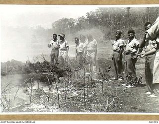 SOUTHPORT, QLD. 1944-01-18. NEW GUINEA NATIVE POLICE BOYS INSPECTING A BUNKER WHICH HAS BEEN ATTACKED WITH A FLAME THROWER MOUNTED ON A MATILDA TANK OF THE 4TH ARMOURED BRIGADE