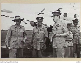 LAE, NEW GUINEA. 1945-03-26. LORD WAKEHURST, GOVERNOR OF NEW SOUTH WALES (3), AND LADY WAKEHURST (4), ON ARRIVAL AT THE AIRSTRIP ON A 2-DAY VISIT TO HEADQUARTERS FIRST ARMY IN THE LAE-NADZAB AREA. ..