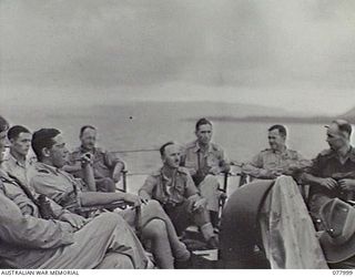 AT SEA. 1944-12-27. VX27 MAJOR GENERAL A. H. RAMSAY, CBE, DSO, ED, GENERAL OFFICER COMMANDING, 5TH DIVISION (7) AND HIS PARTY RELAXING ON THE STERN OF THE RAN VESSEL, ML802 AS SHE PROCEEDS UP THE ..