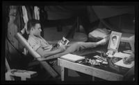 [Serviceman relaxing in his quarters]