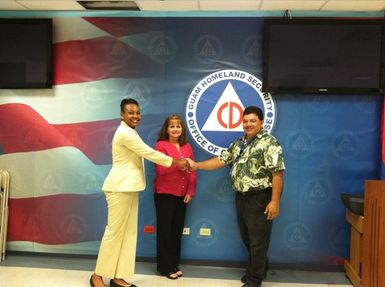 Agana Heights, Guam, July 24, 2012 -- Guam EOC Director James McDonald with and Program Analyst Xushie Brue and FEMA RIX GMD Branch Chief Michelle Weaver. Joint Financial and Programmatic Monitoring visit of Guam Homeland Security Agency