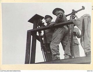 WEWAK AREA, NEW GUINEA, 1945-06-14. GENERAL SIR THOMAS A. BLAMEY, COMMANDER-IN-CHIEF, ALLIED LAND FORCES, SOUTH WEST PACIFIC AREA (1), ON THE OBSERVATION STAND AT BRIGADE HEADQUARTERS DURING HIS ..
