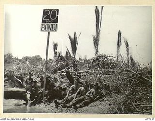 JACQUINOT BAY, NEW BRITAIN. 1944-12-18-20. PERSONNEL OF THE ASSISTANT DIRECTOR OF ORDNANCE SERVICES, 5TH DIVISION, SUNBAKING AT "BONDI BEACH" NEAR THEIR CAMP. IDENTIFIED PERSONNEL ARE:- QX34585 ..