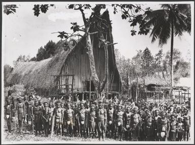 Warriors standing outside the the great dubu daima of Urama, Papua New Guinea, 1921? Frank Hurley