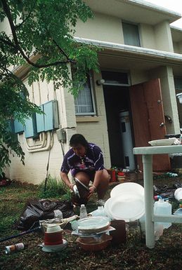 A local resident begins cleaning up after an earthquake struck the region on August 8th and destroyed her home