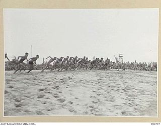 TOROKINA, BOUGAINVILLE, 1945-07-08. COMPETITORS RACE FOR THE WATER AT START OF THE SURF RACE DURING THE CHAMPIONSHIP SURF CARNIVAL CONDUCTED BY ARMY AMENITIES SERVICE, 4 BASE SUB-AREA, AT NO. 4 ..