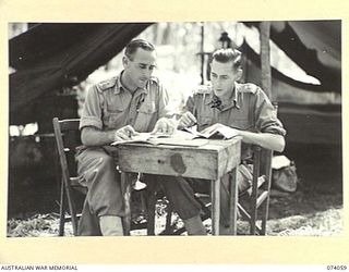 SIAR, NEW GUINEA. 1944-06-20. VX104203 CAPTAIN A.H. DOWNING, OFFICER IN CHARGE (1) AND VX81118 LIEUTENANT R.B. PICKEN, SECOND IN CHARGE (2), OF THE 3RD SUPPLY DEPOT PLATOON AUSTRALIAN ARMY SERVICE ..