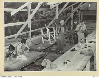 TOROKINA, BOUGAINVILLE. 1945-04-21. THE INTERIOR OF THE HOBBIES SECTION AT 2/3 CONVALESCENT DEPOT. ALTHOUGH NOT QUITE COMPLETED, PATIENTS ARE MAKING GOOD USE OF IT. IDENTIFIED PERSONNEL ARE:- ..