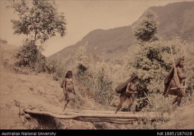 Women crossing bridge, Lai 1958