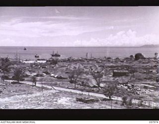 LAE, NEW GUINEA. 1943-10-04. SECTION PHOTOGRAPH OF THE WATERFRONT TAKEN FROM OBSERVATION HILL COVERS BARGE AT SEA ON LEFT TO END OF MOUNTAIN RANGE AT SEA ON RIGHT. TO JOIN TO PHOTOGRAPHS NOS. ..