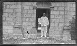 Portrait of man standing on doorstep of building