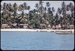 Kaileuna Island: Kaduaga village houses, canoes and beach