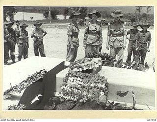 SALAMAUA, NEW GUINEA. 1944-04-30. MEMBERS OF THE AUSTRALIAN ARMY NURSING SERVICE FROM THE 2/7TH GENERAL HOSPITAL AT LAE, EXAMINING WREATHS ON THE CENOTAPH AT THE SALAMAUA WAR CEMETERY. THE OFFICIAL ..