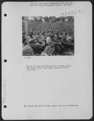 Men of the 38th Bomb Group at Port Moresby, Papua, New Guinea enjoy a good laugh during the Joe E. Brown show. (U.S. Air Force Number 3A32867)