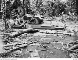TOROKINA, BOUGAINVILLE, 1945-08-02. A BOGGED MATILDA TANK TAKING PART IN WAR OFFICE TRIALS OF THE M24 GENERAL CHAFFEE LIGHT TANK, VIEWED FROM ITS LEFT SIDE AND SHOWING THE DEPTH TO WHICH IT HAD ..