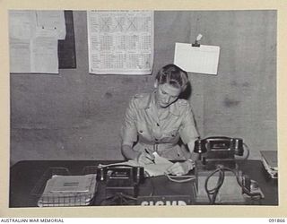 LAE, NEW GUINEA, 1945-05-16. LIEUTENANT M. PHILLIPS, SIGNALMASTER, AT HEADQUARTERS FIRST ARMY. AUSTRALIAN WOMEN'S ARMY SERVICE PERSONNEL ARE TAKING OVER THEIR NEW DUTIES IN ORDER TO RELEASE MALE ..