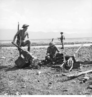 MILNE BAY, PAPUA. 1942-09. AUSTRALIAN SOLDIERS WITH TYPE 94 37MM GUNS FROM JAPANESE TANKS THAT WERE DISABLED AFTER LANDING AT MILNE BAY. THE JAPANESE REMOVED THE GUNS FROM THE TANKS AFTER THE ..