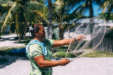 Co-collector Siniva Kalolo holding fishing net, Atafu, Tokelau