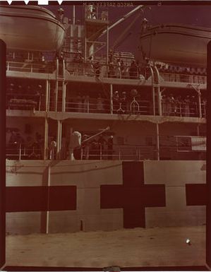 Photograph of Survivors of the USS Indianapolis (CA-35) Lined Up on Side of USS Tranquillity (AH-14) as She Docks at Guam