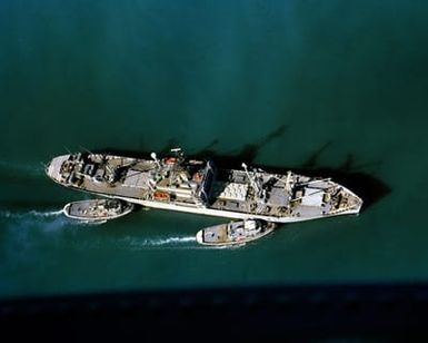 Harbor tugs position the cable transport ship USNS FURMAN (T-AK 280)