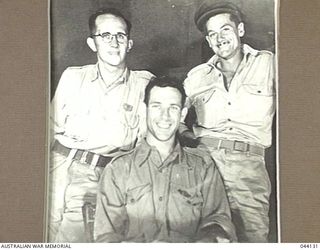 THREE PROMINENT WAR CORRESPONDENT/PHOTOGRAPHERS WHO COVERED AUSTRALIAN FORCES IN THE PACIFIC. L-R (STANDING) ALAN ANDERSON AND JIM FITZPATRICK, SITTING DAMIEN PARER. PARER WHO HAD SERVED WITH ..