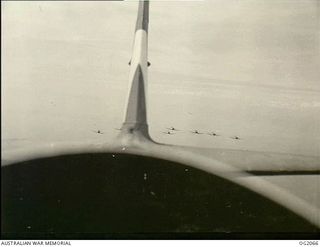 AIRBORNE OVER BOUGAINVILLE ISLAND, SOLOMON ISLANDS. 1945-01-17. PHOTOGRAPH TAKEN FROM A WIRRAWAY AIRCRAFT OF NO. 5 (ARMY CO-OPERATION) SQUADRON RAAF WHICH ALSO ACT AS PATHFINDERS TO ROYAL NEW ..