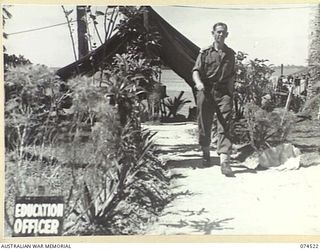 MATUPI, NEW GUINEA. 1944-07-04. VX52501 LIEUTENANT E. LESH, EDUCATION OFFICER OF THE 15TH INFANTRY BRIGADE, WALKING ALONG A PATH NEAR HIS TENT OFFICE