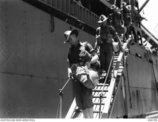 TOWNSVILLE, QLD. 1944-01-28. PERSONNEL OF THE 2/28TH INFANTRY BATTALION, PROCEEDING DOWN THE GANGWAY OF THE TROOPSHIP, "VAN HEUTSZ" ON THEIR RETURN HOME FROM NEW GUINEA. IDENTIFIED PERSONNEL ARE:- ..