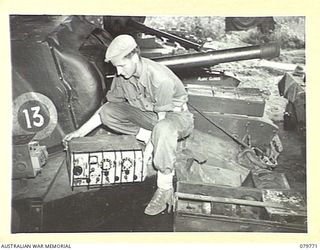 AITAPE, NEW GUINEA. 1945-03-16. A NO.19 MK 2 (AUSTRALIAN) WIRELESS SET HELD BY A TROOPER OF THE 2/4TH ARMOURED REGIMENT, AUSTRALIAN ARMOURED CORPS. THE SET DOES NOT FIT THE PRESENT BRITISH ..