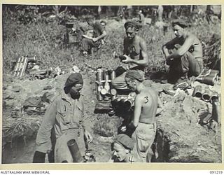 TOKO, BOUGAINVILLE. 1945-04-25. THE MORTAR CREW OF 5 DETACHMENT, HEADQUARTERS COMPANY, C COMPANY ADVANCE ALONG BUIN ROAD SOUTH OF SINDOU RIVER. THE ATTACK, SUPPORTED BY THREE MATILDA TANKS FROM B ..