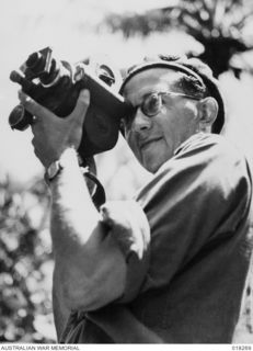 Henry Reid Bay, New Britain. 20 March 1945. Mr. Alan Anderson, movie man of the Department of Information who is covering the Australian campaign in New Britain