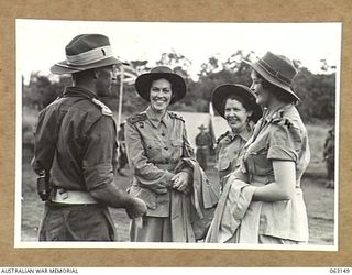 DONADABU, PAPUA, NEW GUINEA. 1944-01-01. MEMBERS OF THE STAFF OF THE 2/5TH GENERAL HOSPITAL ENJOY A CHAT AT THE 15TH AUSTRALIAN INFANTRY BRIGADE GYMKHANA. SHOWN ARE: VX102648 CAPTAIN C. C. ..