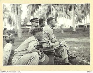 MILILAT, NEW GUINEA. 1944-08-06. AUSTRALIAN ARMY OFFICERS WATCHING A SOCCER GAME BETWEEN TEAMS FROM HEADQUARTERS, 5TH DIVISION AND THE 4TH INFANTRY BRIGADE DURING THE OPENING MATCH AT THE NEW ..