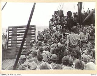 KAHILI, BOUGAINVILLE. 1945-10-02. JAPANESE ARMY TROOPS FROM THE BUIN AREA CROWDED ON THE DECK OF THE NEENA. THEY HAVE JUST COME ABOARD FROM AUSTRALIAN LANDING CRAFT AND ARE EN ROUTE TO THE ..