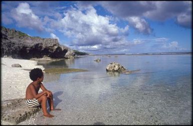 Young boy looking out to sea