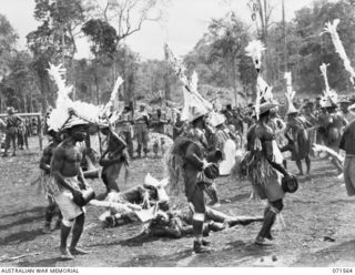 SONG RIVER, FINSCHHAFEN AREA, NEW GUINEA. 1944-03-26. FINSCHHAFEN BOYS DANCING DURING A NATIVE SING-SING IN THE AUSTRALIAN NEW GUINEA ADMINISTRATIVE UNIT COMPOUND TO CELEBRATE THE RE OCCUPATION OF ..