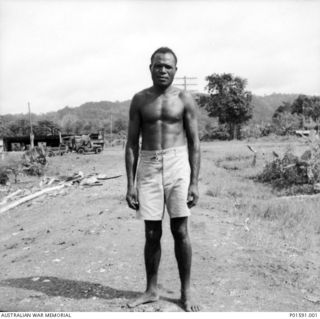 LAE, NEW GUINEA. C.1945. SERGEANT MAJOR POGONAU, SENIOR NON-COMMISSIONED OFFICER, POLICE BOYS, AT THE FAR EASTERN LIAISON OFFICE HEADQUARTERS