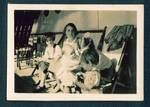 Kath Honesett, sitting far left with unidentified women and children sitting on deck of the Ballarat, c1932 to 1933
